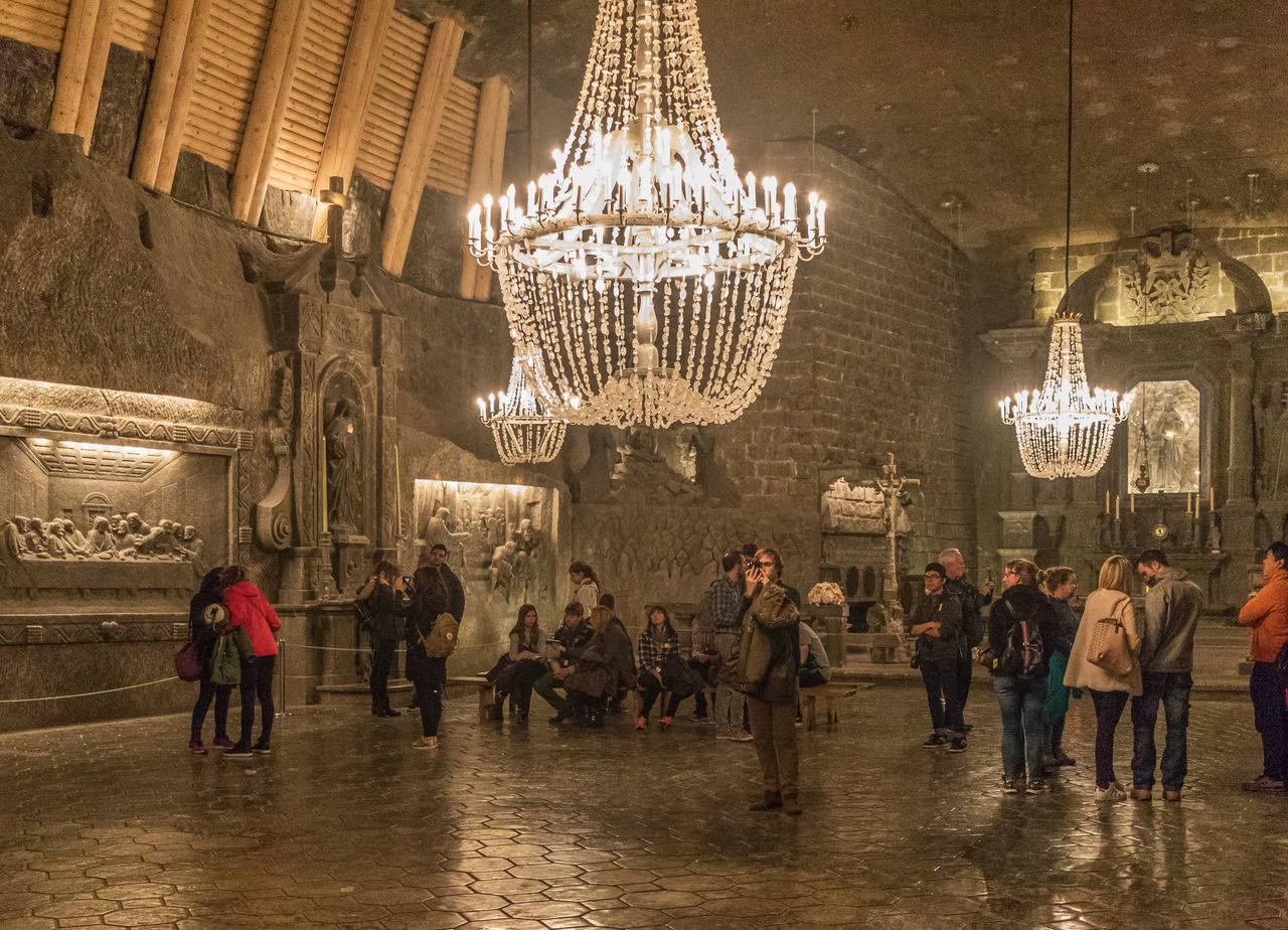 GROUP OF PEOPLE WALKING ON ILLUMINATED CEILING