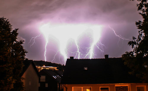 Low angle view of houses against sky at night
