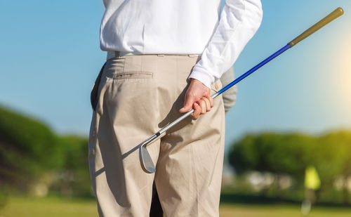 Rear view of man holding umbrella