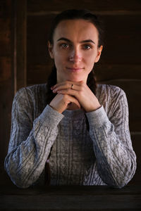 Portrait of young woman drinking coffee at home