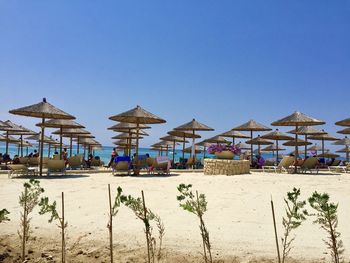 Built structure on beach against clear blue sky