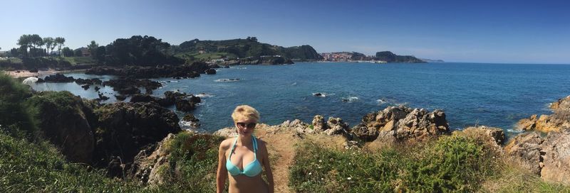 Panoramic view of woman standing against sea