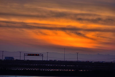 Silhouette train against sky during sunset