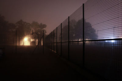 Silhouette of fence at sunset