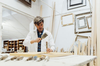 Carpenter with tools working at workshop