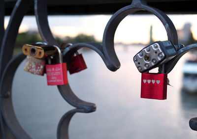 Close-up of padlocks hanging on railing