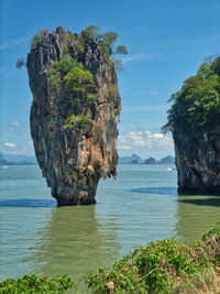 Scenic view of rock formation in sea against sky