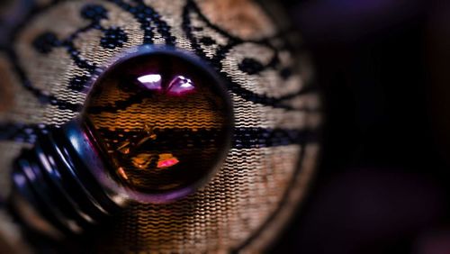 Close-up portrait of eye over black background