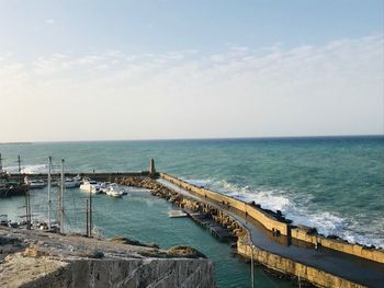 Pier over sea against sky