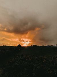 Scenic view of field against sky during sunset