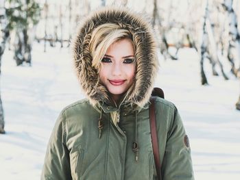 Portrait of smiling young woman in snow