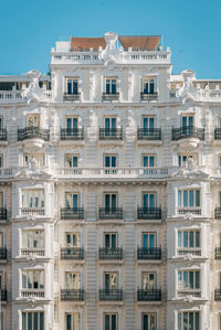 Low angle view of buildings against clear blue sky