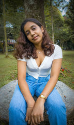 Portrait of young woman sitting outdoors