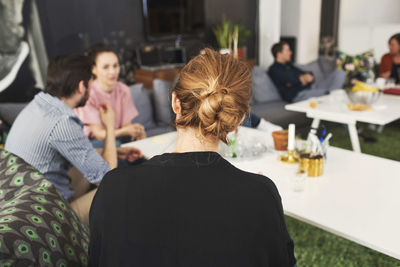 Businesswoman with colleagues discussing in office lobby