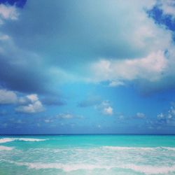 Scenic view of sea against cloudy sky