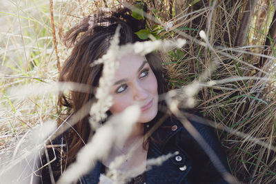 Portrait of a young woman lying on field