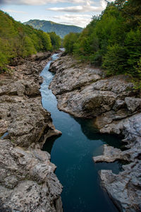 High angle view of stream amidst rocks