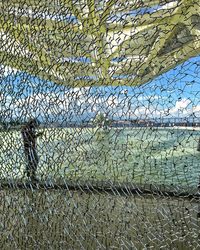 Full frame shot of fishing net against sky