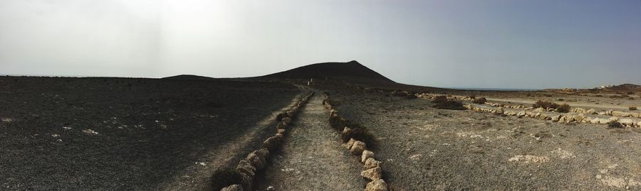 Panoramic view of road on desert against sky