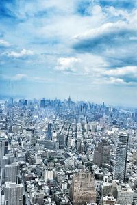High angle view of cityscape against cloudy sky