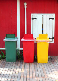 Colorful garbage cans by window