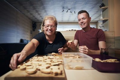 Portrait of smiling couple sitting at home