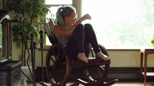 Woman sitting on chair at home