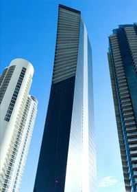 Low angle view of modern buildings against clear blue sky