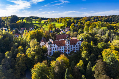 High angle view of trees and buildings against sky