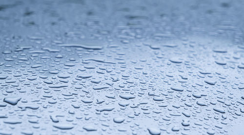 Close up rain drop on surface of car's body after passed from rainy area