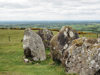 Hay bales on field against sky