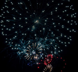 Low angle view of firework display at night