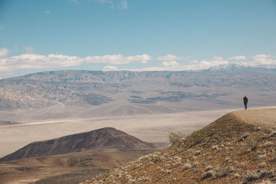 Man standing on desert against sky
