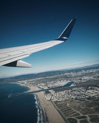 Cropped image of airplane flying over sea
