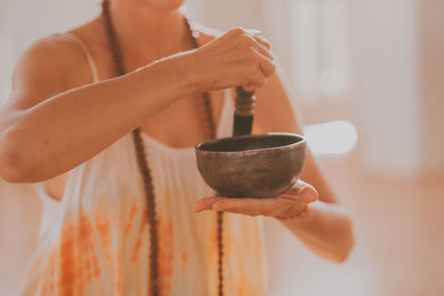 Female hands play meditation on tibetan bowls