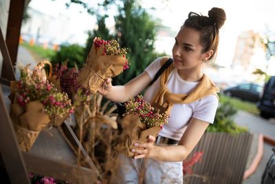 Rear view of woman holding bouquet