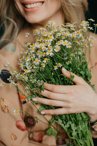 Midsection of woman holding christmas tree