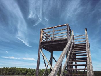 Low angle view of old metallic structure against sky