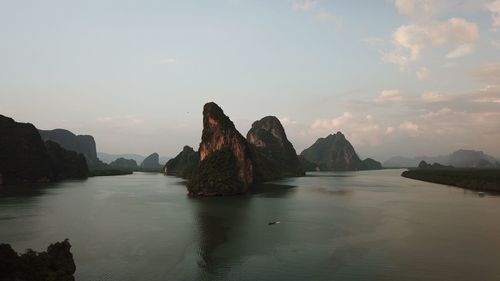 Scenic view of sea and mountains against sky