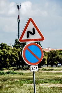 Close-up of road sign against sky