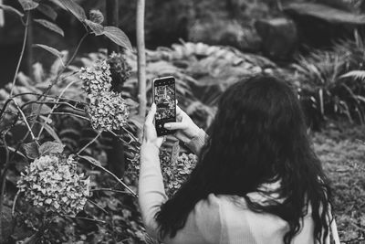 Woman photographing with mobile phone