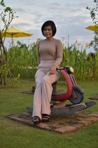 Portrait of smiling young woman on field