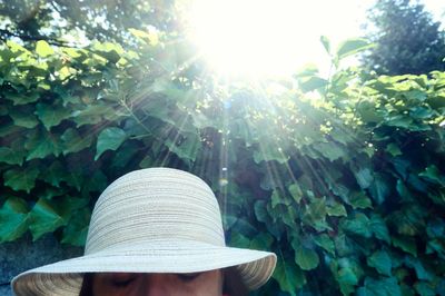 Person wearing hat against trees