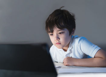 Portrait of boy looking at camera at home