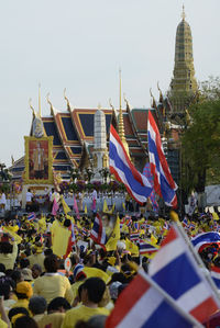 High angle view of people with thai flags at event outside temple