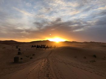 Scenic view of desert against sky during sunset