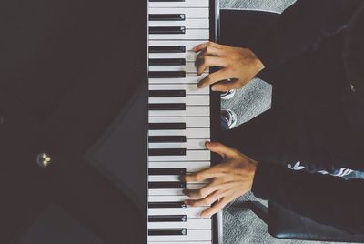 Low section of man playing piano