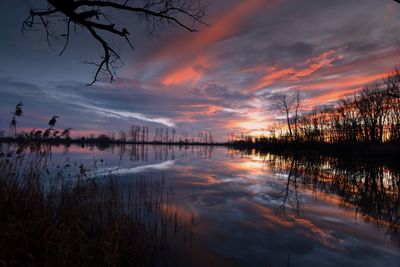 Scenic view of lake against sky at sunset