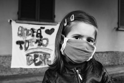 Close-up portrait of girl wearing mask outdoors