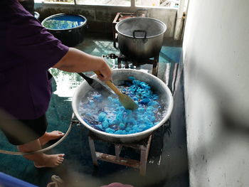 High angle view of man boiling textile